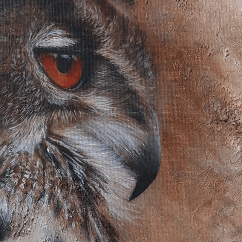 Close-up of a painted owl head with detailed brown, gray, black, and white feathers and a vivid orange-red eye on a textured brown background.